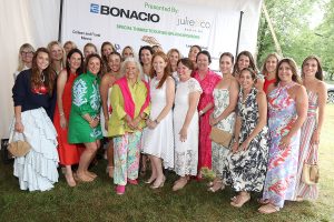 A large group of attendees posed together outdoors in front of a sponsor banner reading Presented By Bonacio and Julie & Co. Realty at the Saratoga Hospital Foundation event.